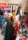 Home Lively outdoor market showcasing diverse culture and bustling activity with colorful attire and goods.